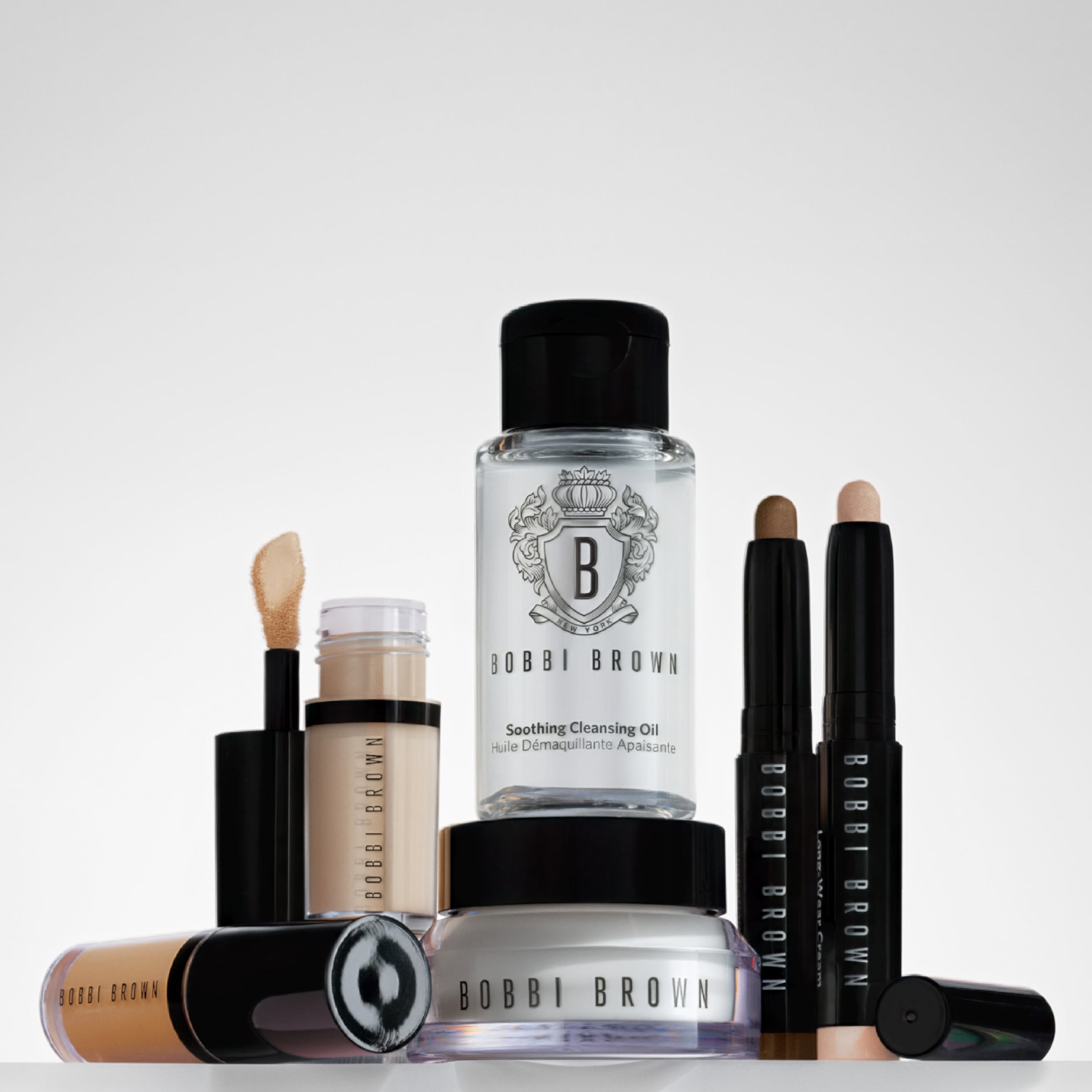 Close up of model applying Crushed-Oil Infused Gloss to lips